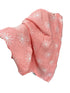Pink blanket with white floral patterns