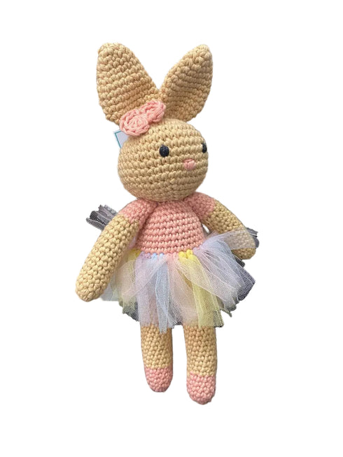 Hand-crocheted bunny toy with a pink dress on a white background