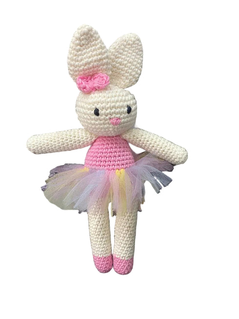 Crocheted bunny toy with a pink bow and tutu on a white background