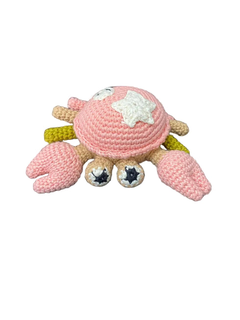 Crocheted crab toy with pink shell on a white background