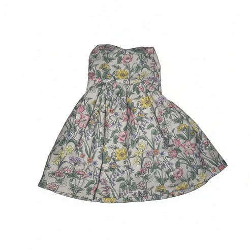 A sleeveless dress with a colorful pink, yellow, and green floral prinT