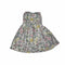 A sleeveless dress with a colorful pink, yellow, and green floral prinT