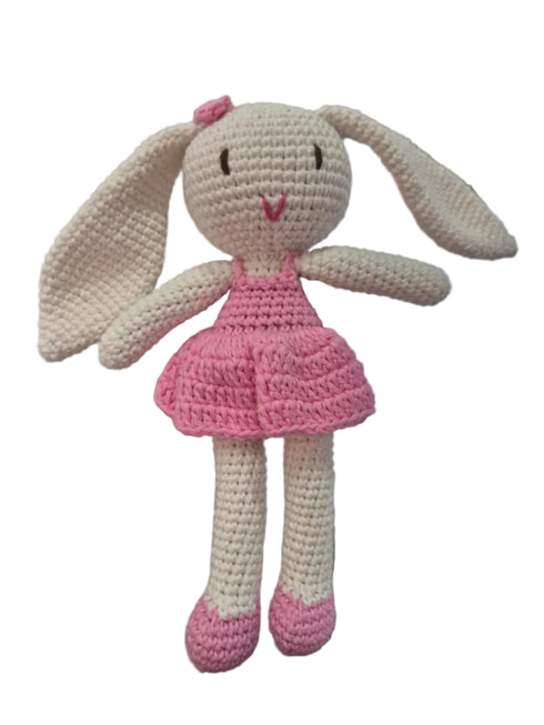 A handmade crocheted bunny doll with long cream ears, a pink dress, and pink shoes.