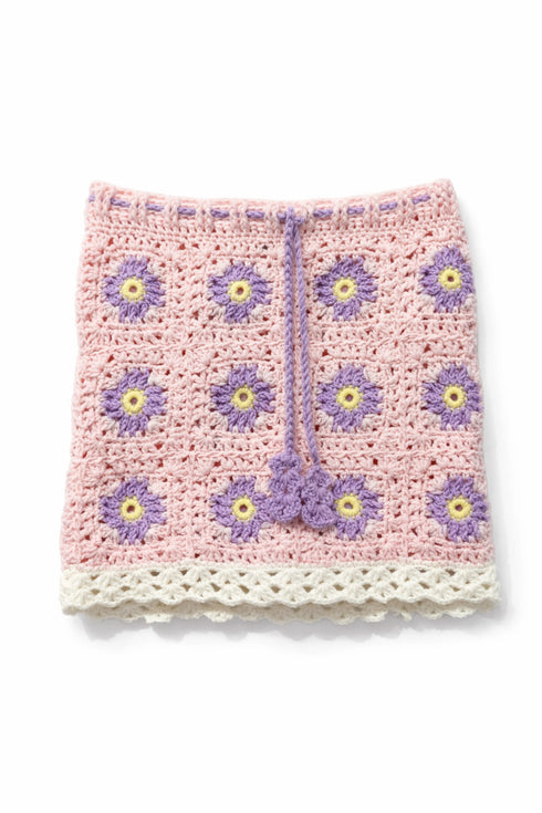 Crocheted baby blanket with flower patterns on a white background