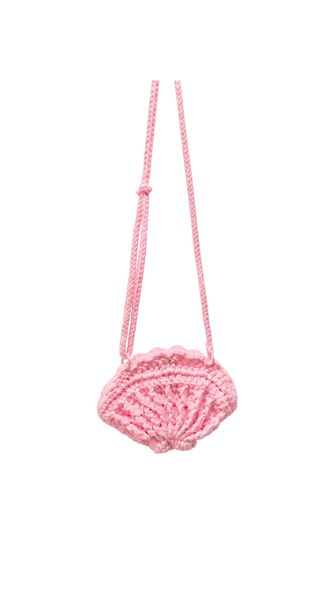 A small pink crocheted shoulder bag with a long braided strap