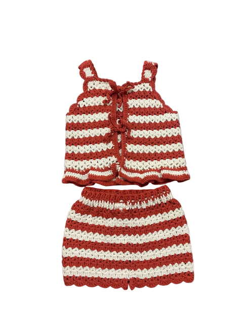 Crocheted red and white striped top and skirt set on a white background