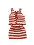 Crocheted red and white striped top and skirt set on a white background