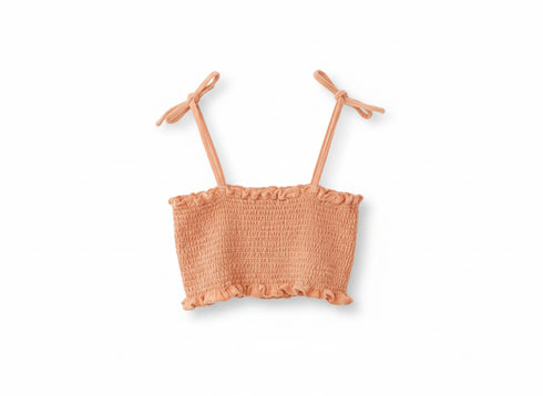 Peach-colored crop top with thin straps on a white background