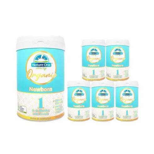 Multiple containers of Nature One Organic Newborn baby formula milk powder, with the product packaging displaying the brand logo, organic certification, and product information.