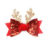 Red and gold glitter bow with reindeer antlers on a white background