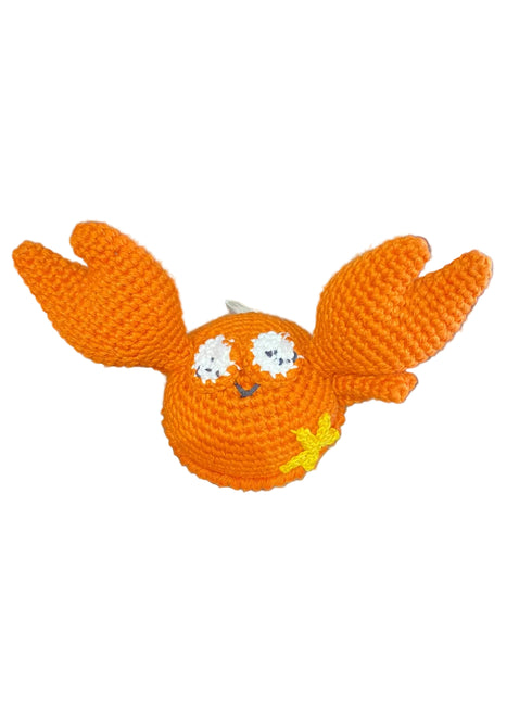 Orange knitted toy resembling a creature on a white background