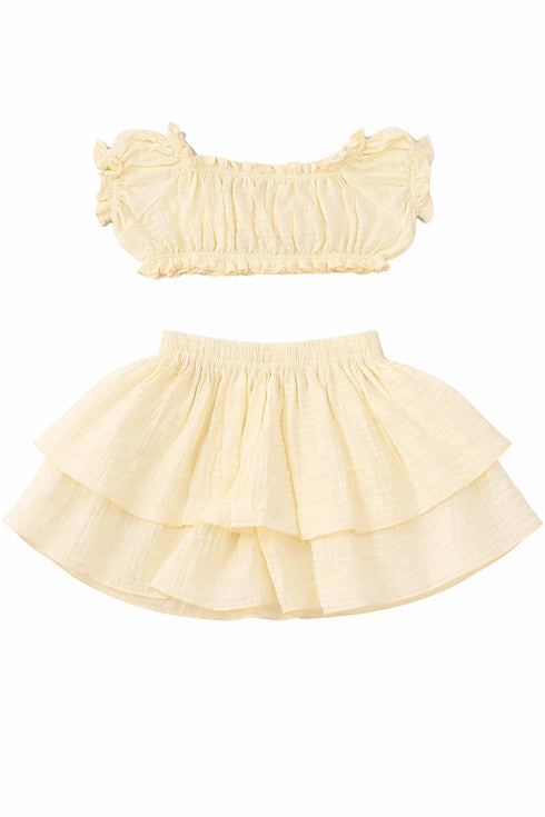 Two-piece outfit with a bandeau top and ruffled skirt on a white background