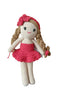 Crocheted doll with a red dress and headband on a wooden background