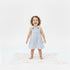 Child wearing a blue and white striped dress on a white background