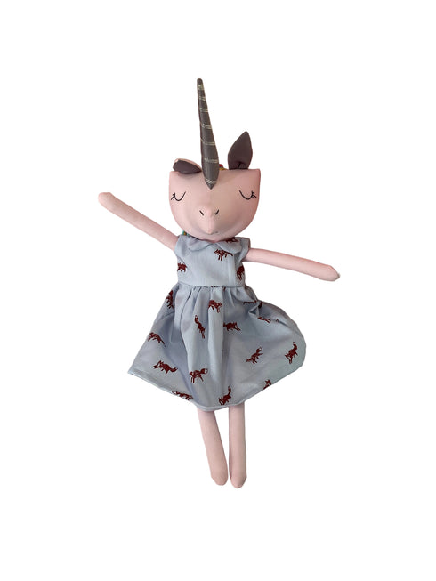 A plush unicorn doll with pink skin, a gray horn, and a light blue dress printed with small red dragon motifs