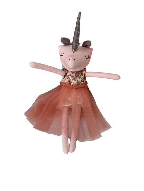 A plush unicorn doll with a pink body, gray horn, and a peach tulle dress.