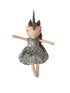 A handmade plush doll with a pale peach face and limbs, wearing a green floral dress.