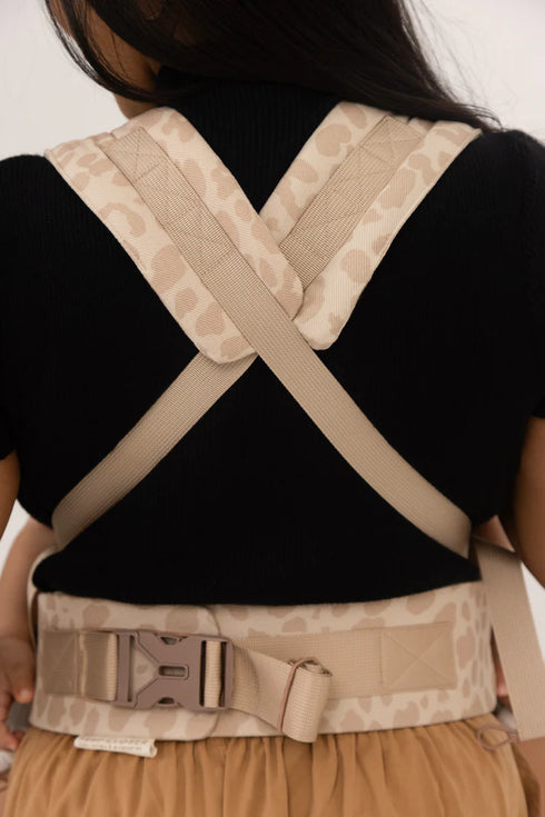 Person wearing a beige back brace on a plain background