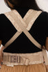 Person wearing a beige back brace on a plain background