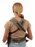 Person wearing a green and brown tactical belt with shoulder straps on a white background