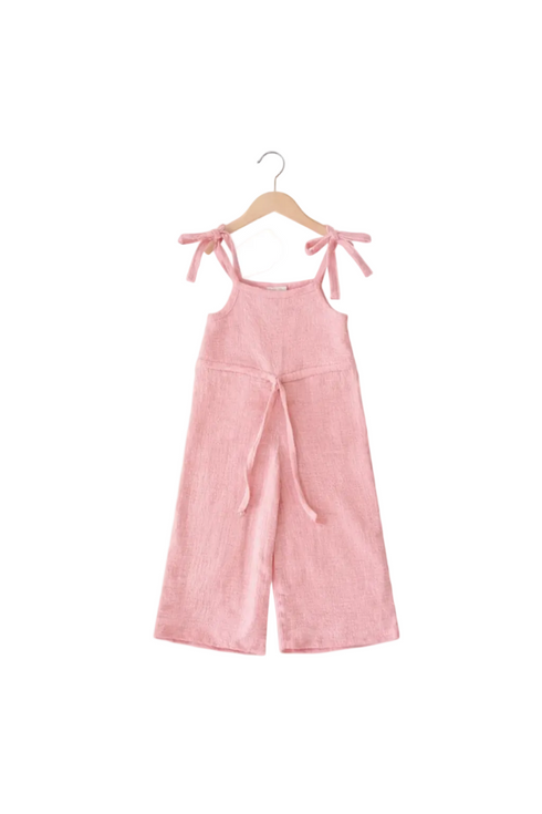 Pink jumpsuit with bow straps on a hanger against a white background