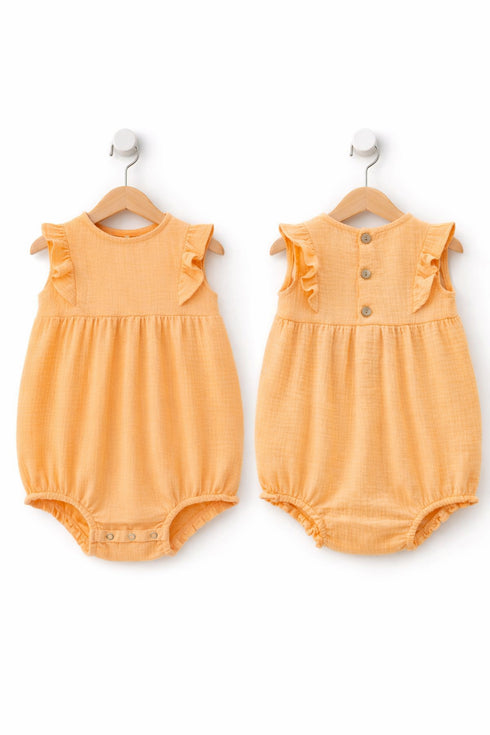 Two orange baby rompers with ruffled shoulders on hangers against a white background