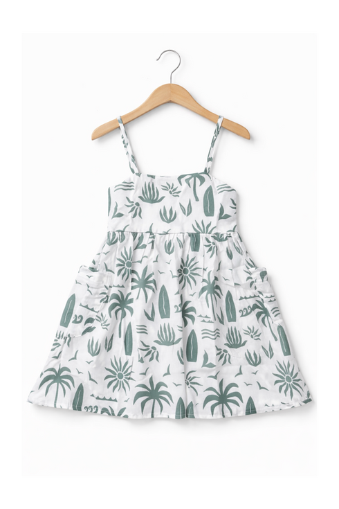 White dress with green plant pattern on a hanger against a white background