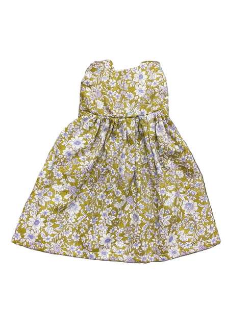 Floral dress with yellow and purple pattern on a white background