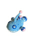 Blue crochet toy with pink accents on a reflective surface