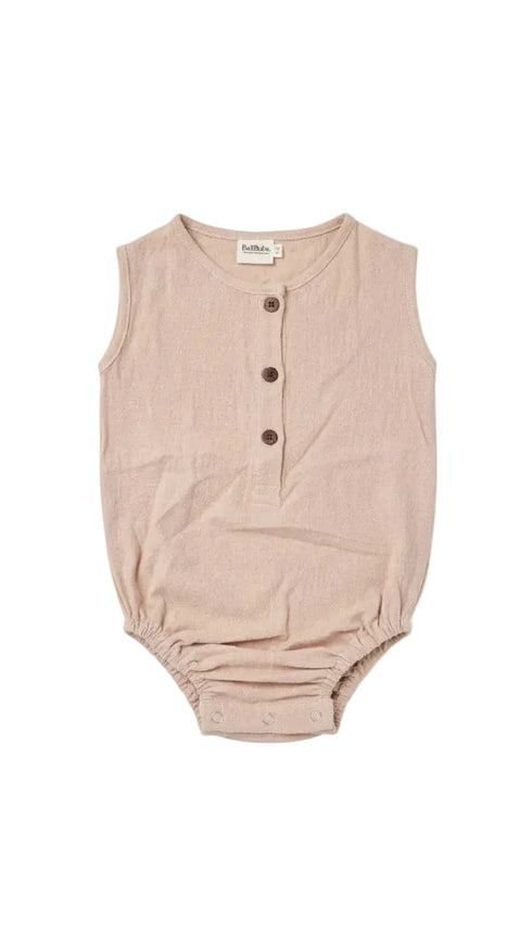 A sleeveless baby romper in a light dusty pink or beige linen-like fabric, featuring a three-button henley neckline and elasticized leg openings