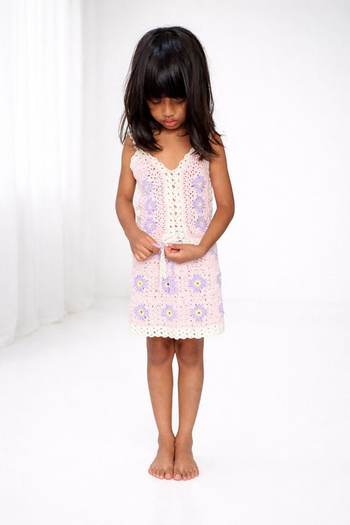 Young girl wearing a floral dress on a white background