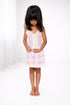 Young girl wearing a floral dress on a white background