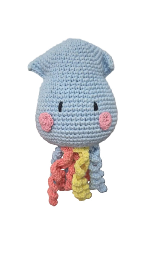 A handmade crocheted octopus plush toy. The octopus has a light blue body, pink cheeks, and wavy tentacles in yellow, orange, and pink.