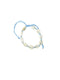 Bracelet with blue string and white beads on a white background