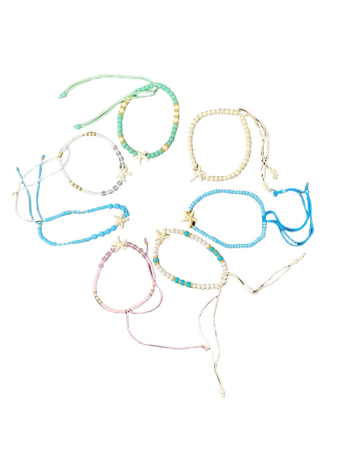 Set of colorful beaded bracelets on a textured surface
