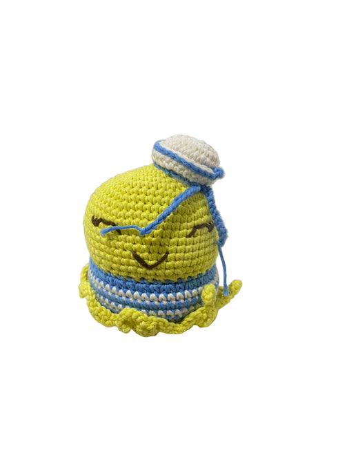 Crocheted toy with a yellow face and blue accents on a white background