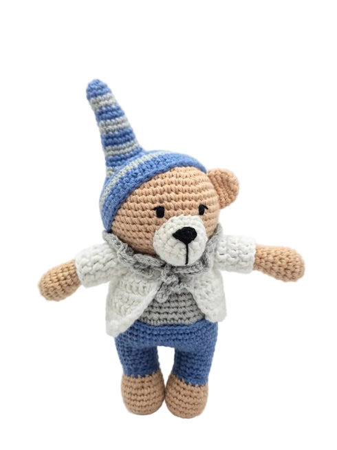 A crocheted teddy bear doll wearing a blue and white striped pointed hat