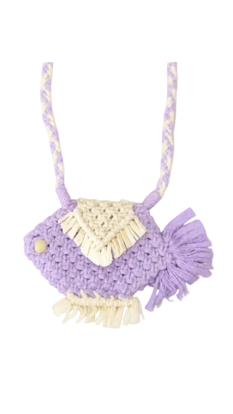 A handmade crocheted fish-shaped bag in lavender purple and cream, featuring a braided shoulder strap, cream fringe detail