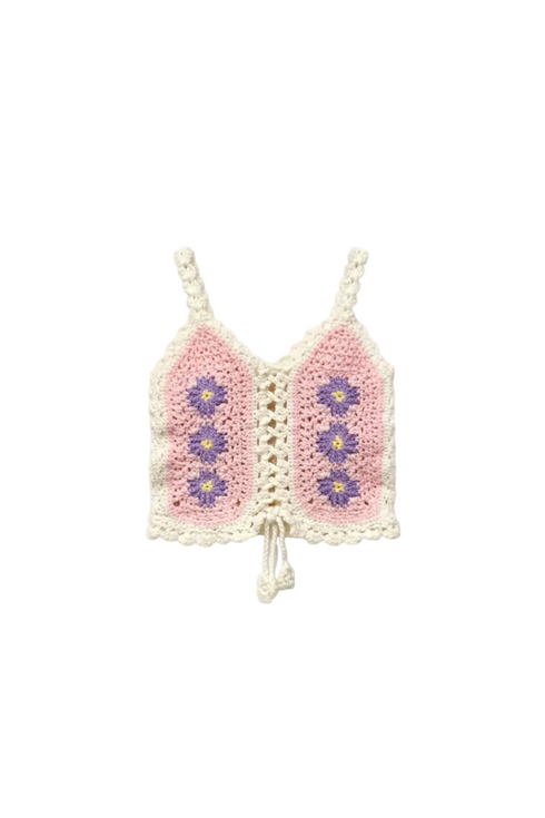 Crocheted pink and white top with floral patterns on a white background