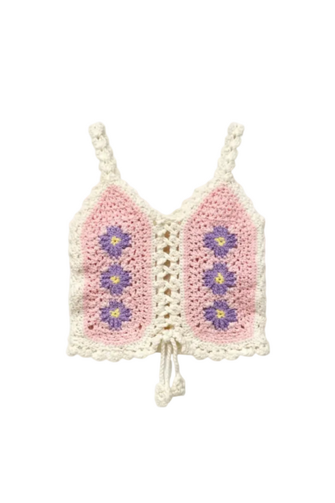 Crocheted pink and white top with floral patterns on a white background