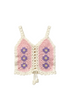 Crocheted pink and white top with floral patterns on a white background