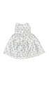 White dress with blue polka dots on a white beground