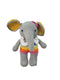 A handmade crocheted elephant toy held in a person's hand, featuring a gray body, yellow inner ears, white tusks, and a rainbow-striped chest.