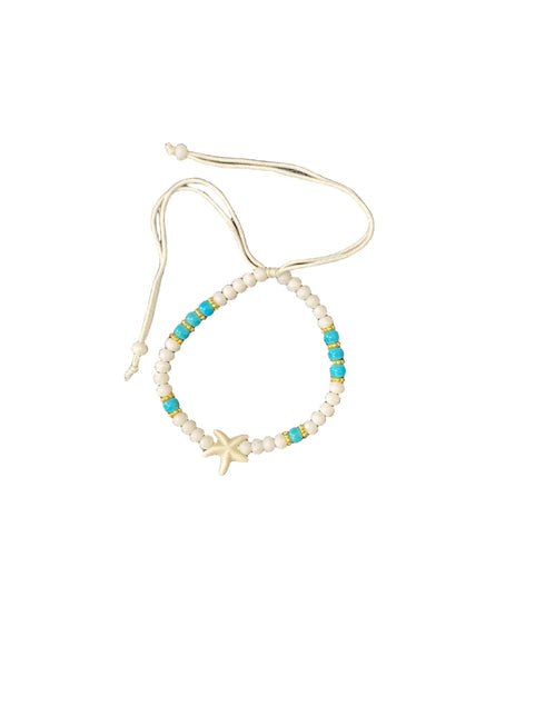 Beaded bracelet with starfish charm on white background