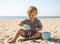 Child playing with sand on a beach