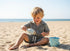 Child playing with sand on a beach