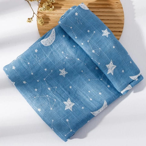 Blue fabric with star and moon patterns on a wooden board