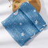 Blue fabric with star and moon patterns on a wooden board