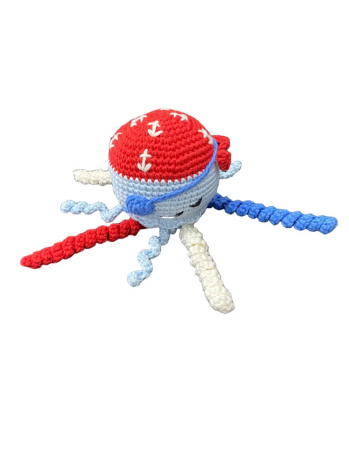 Crocheted pirate-themed plush toy on a white board