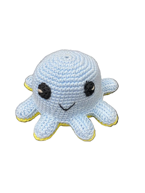 Crocheted Jellyfish toy with black eyes and yellow accents